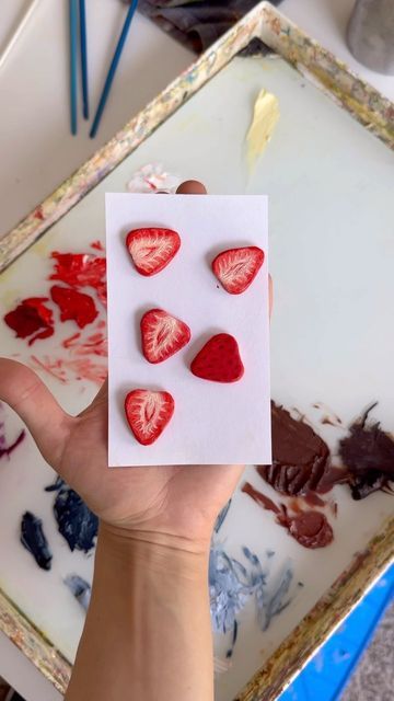 Amanda Eve on Instagram: "painting little strawberry pieces for my waffle board! in love with these 🥹🍓 - - - #oilpainting #paintingprocess #artistoninstagram #oilpaintingprocess #contemporarypainting #airdryclay #clayart #fruitart #strawberry" How To Make A Clay Strawberry, How To Paint Strawberries Acrylic, Strawberry Air Dry Clay, Strawberry Clay Art, Strawberry Ceramics, Painting On Random Things, Amanda Eve, Paint Strawberries, College Sketchbook