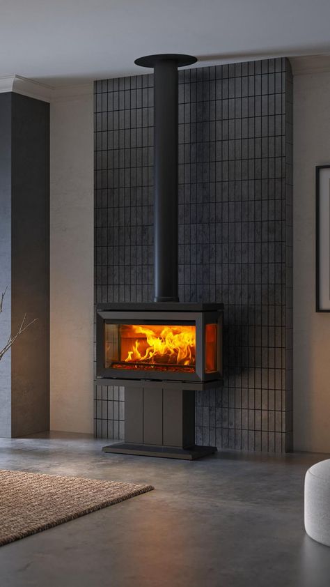 Large black wood-burning stove in a modern living room with concrete floor and dark grey tiles on wall Wood Stove Modern, Indoor Wood Stove, Wood Stove Decor, Large Stove, Modern Woodburner, Woodburning Stove Fireplace, Stove Decor, Small Wood Burning Stove, Wood Burning Stoves Living Room