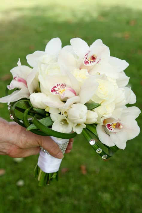 white bridal bouquet, white, orchids, tulips, freesia, lily grass Tulip Orchid Bouquet, Orchid And Tulip Bouquet, Mini Orchid Bouquet, Cymbidium Orchids Bouquet, Bridal Bouquet Orchids, Bridal Bouquet With Orchids, Lilies And Orchids, Freesia Bouquet, White Orchid Bouquet