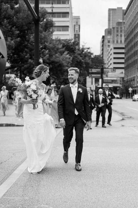 Couple walking down the street in downtown des moines smiling and laughing together Iowa Wedding Venues, Downtown Des Moines, Iowa Wedding, Adventure Photographer, Des Moines Iowa, Urban Wedding, Iowa City, City Vibe, Cedar Rapids