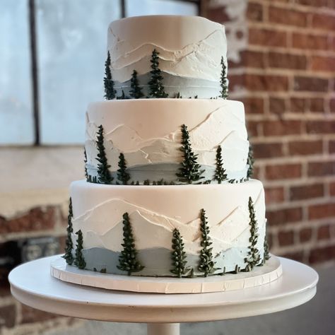 This continues to be one of our most popular designs. I can totally see why!  To sweeten your celebration with a custom cake of your own, you can:  Call 720.270.4042⁠ Text 720.432.6417⁠ DM⁠ Email info@themakery.com⁠ or simply fill out our cake quote inquiry form at the top of the link in our bio. ⁠  For our cake-making friends: Gel paste food color: https://amzn.to/3VDCWZp 12-inch round drum: https://amzn.to/3P6D9BE Fondant: https://amzn.to/3pg3rbd Pearly luster spray: https://amzn.to/42pXw1Y Nature Wedding Cake Ideas, Wedding Cake Woodsy, Rustic Winter Wedding Cake, Mountain Themed Wedding Cake, Outdoorsy Wedding Cake, Green And Blue Wedding Cake, Mountain Themed Cake Ideas, Warhammer Cake, Rustic Cake Ideas