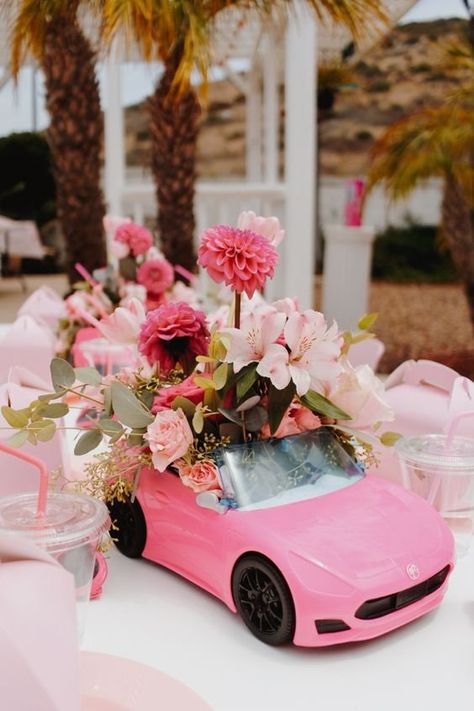 Pretty In Pink: Throw a Barbie Themed Bridal Shower Barbie Car Floral Arrangement, Balloon Garland On Pop Up Tent, Barbie Mimosa Bar, Barbie Wedding Theme, Barbie Bridal Shower Ideas, Barbie Centerpieces Ideas, Barbie Centerpiece, Barbie Flowers, Barbie Party Favors