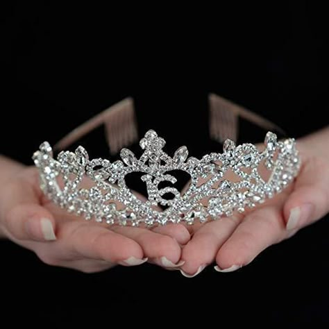 Ella Celebration Sweet 16 Heart Tiara FIT FOR A QUEEN: Make her feel like royalty on her big day with this high quality, festive tiara. You may find she likes wearing it long after the party is over! Thanks to the high-quality design, this tiara can be kept as a keepsake for years to come! METAL DESIGN MEANS HIGHER QUALITY: Unlike many tiaras that are made of plastic, this one is made of silver metal alloy with crystal rhinestones. MAKES GREAT PHOTOS: Capture all her royal glory all day long as Sweet 16 Jewelry Ideas, Shoes For Sweet 16, Pink Sweet 16 Tiara, Tiara Sweet 16, Make Up Sweet 16, Sweet Sixteen Crown, Sweet 16 Court Proposals, Sweet 16 Pink And Purple Theme, Sweet 16 Tiara Crowns