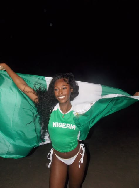 a black girl in a ‘nigeria’ baby tee carrying the nigerian flag on a beach at night Lagos Nigeria Aesthetic, Nigeria Aesthetic, Nigerian Aesthetic, 90s Swimwear, Travel Core, Nigerian Independence, Nigeria Travel, Nigeria Flag, Cute Bible Verses