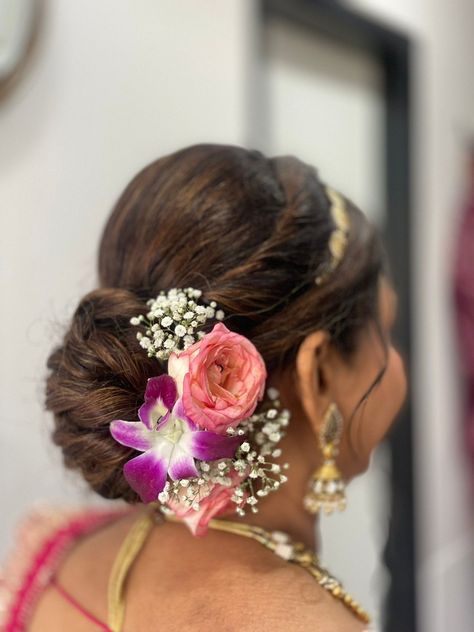 Flower Whisperer: Graceful Bun Hairstyles with a Hint of Floral Charm Marathi Bridal Hairstyles Indian, Flowers For Bun Hairstyle, Bun Hairstyles For Mom, Bride's Mom Hairstyle Indian, Indian Mother Hairstyles For Wedding, Messy Bridal Bun Indian, Bride Mom Hairstyle Indian, Messy Bun With Flowers, Hairstyles For Mother Of The Bride