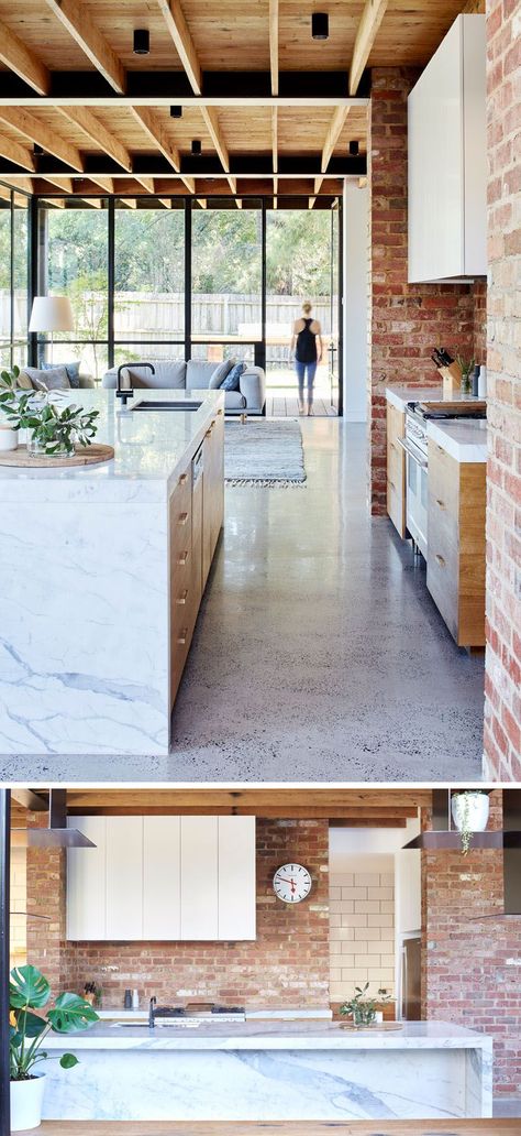 In this modern kitchen, red brick, some of which was recycled from the garden paving, covers the wall and compliments the timber paneled cabinet doors and the Statuario marble used for the countertops and island. Modern Konyhatervezés, Panel Cabinet Doors, Marble Kitchen Island, Brick Kitchen, Timber Panelling, Best Kitchen Designs, Brick Walls, Kitchen Marble, Trendy Kitchen