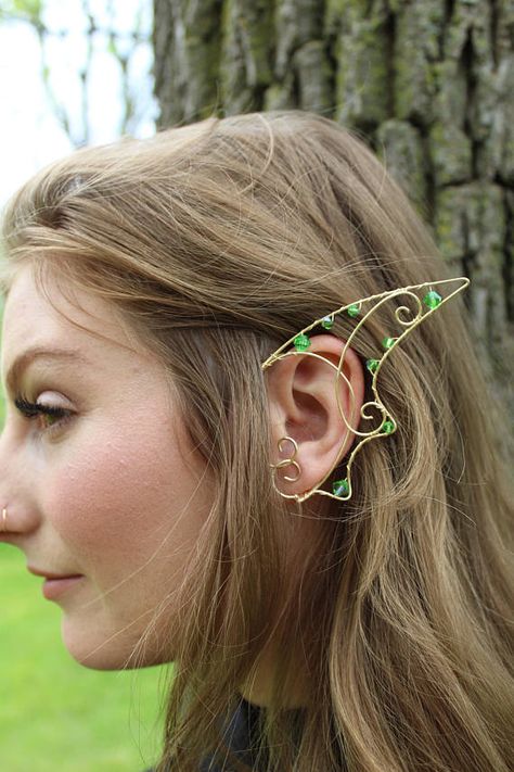 These ear cuffs are inspired by scalloped dragon wings. They are made in a gold coloured copper wire, interspersed with light green crystal beads. They are light and adjustable to make the fit more comfortable, or even tighter. They are perfect for cosplay or even a game of make believe Fairytale Cosplay, Dragon Ear Cuffs, Elf Ear, Elf Ear Cuff, Fairy Ears, High Elf, Elf Ears, Geode Earrings, Fairy Wands