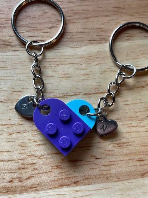 **Lego Heart Keychain** Celebrate your love, friendship or connection with this adorable Lego Heart Keychain! This delightful keychain features two interlocking heart pieces made from genuine Lego bricks. It symbolizes the bond between you and your loved one, serving as a reminder of your special relationship wherever you go. **Personalize the keychain heart with the initial of your loved one. **Product Details:** - Material: Authentic Lego bricks - Color: Red, purple, blue, sand green, mediu Cute Gifts For Girlfriend Birthday, Lego Keychain Couple, Lego Heart Keychain, Computer Homescreen, Bricks Color, Lego Bracelet, Lego Keychain, Lego Heart, Ceramic Souvenir