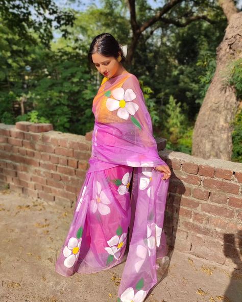 Indulge in the timeless elegance of hand-painted artistry with our exquisite lilac floral organza saree. Each delicate petal and intricate vine is meticulously crafted by skilled artisans, making every piece a unique work of wearable art. Elevate your style with the ethereal charm of this saree, perfect for special occasions or adding a touch of sophistication to your everyday ensemble. Embrace tradition with a contemporary twist in this stunning creation. #HandPaintedSaree #FloralElegance #O... Hand Painted Sarees Floral, Floral Organza Saree, Clothes Painting, Saree Floral, Hand Painted Sarees, Organza Sarees, Organza Saree, Wearable Art, Ramadan