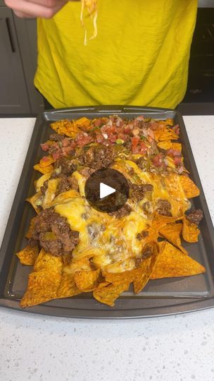 Sheet pan nachos are a hit | Sheet pan nachos are a hit

Brian L makes a dorito nacho dinner with enchilada sauce, ground beef, and pico de gallo

This original video was produced by... | By Kiera & Ryan & Danny & Justine | So here on a baking sheet
you're going to want to make sure you grab two bags of
cheese. I grabbed this Mexican four cheese blend because it
was on sale which is my favorite kind of cheese to get.
So here out to the side I have some ground beef. And I'm
going to be pouring some red enchilada sauce on that. So I'm
not doing my typical taco seasoning for this. I wanted to
try something different. So I figured if we mix the ground
beef with this red enchilada sauce it is going to give us so
much flavor. And this smells amazing already. So I'm just
going to be doing nice bi Nacho Dinner, Ground Beef Nachos, Sheet Pan Nachos, Doritos Taco, Pan Nachos, Taco Mix, Pork Nachos, Nachos Beef, Red Enchilada Sauce