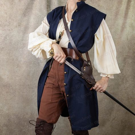 This cotton linen vest is inspired by 18th century waistcoasts and medieval surcoats. Made with rich linen fabric, this tunic vest is the perfect layer for completing a pirate, knight, captain, prince charming, or historical gentleman costume. Layer it over one of our Darcy Shirts with our Wide Leather Waist Belt to complete the look. SIZING: This shirt offers a straight, relaxed fit through the chest and waist. Choose your size according to your largest measurements. S ~ Chest/Waist/Hips Up to 38" M ~ Chest/Waist/Hips Up to 42" L ~ Chest/Waist/Hips Up to 46" XL ~ Chest/Waist/Hips Up to 50" 2XL - Chest/Waist/Hips Up to 54" Fiber Content: 50% Cotton/30% Linen/20% Polyester Machine Wash Cold with Like Colors,  Tumble Dry Low or Line Dry for Best Results Made in China Using Sustainable Produc Knight Captain, Pirate Vest, Linen Waistcoat, Ren Faire Outfits, Tunic Vest, Pirate Cosplay, Corset Shop, Pirate Outfit, Fair Outfits