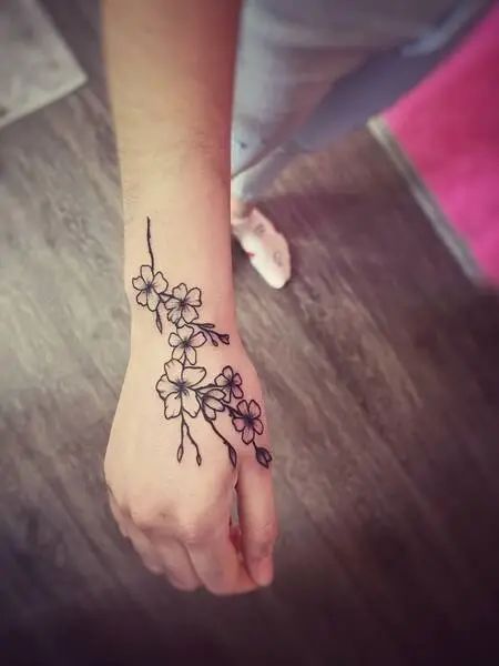 Cherry Blossom Tattoo On Hand, Hand Tattoos For Women Japanese, Sakura Hand Tattoo, Cherry Blossom Hand Tattoos For Women, Cherry Blossom Henna, Cherrybloom Tattoo, Cherry Blossom Tattoo Black And White, Japanese Cherry Blossom Tattoo Back, Cherry Blossom Hand Tattoo