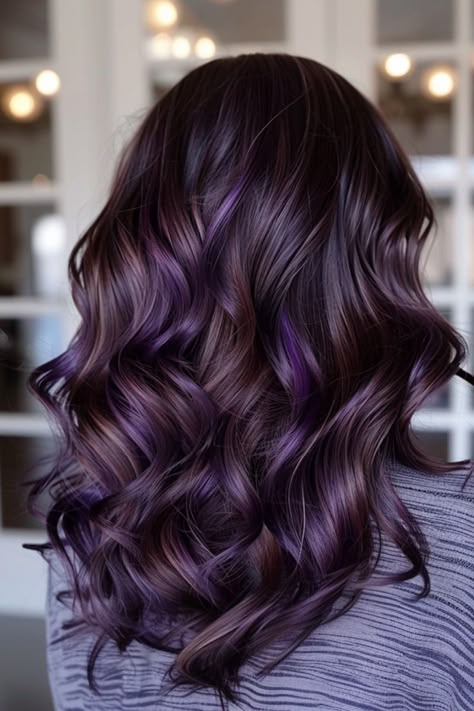 Enhance your natural brown hair with a stunning mix of purple highlights. This vibrant combination creates a bold, eye-catching look that exudes confidence and style. Brunette To Purple Ombre, Fall Purple Hair Color For Brunettes, Purple Low Lights For Black Hair, Dark Hair With Purple And Blonde Highlights, Plum Purple Highlights Brown Hair, Red Purple Highlights On Dark Hair, Subtle Pops Of Color In Hair, Dark Purple Hair With Brown Plum Highlights Balayage, Dark Brown Hair With Dark Purple Highlights