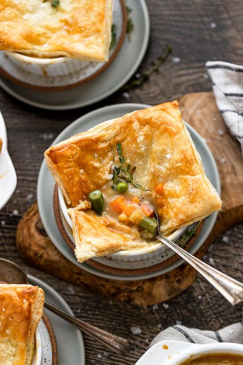 Individual Vegetarian Pot Pies are easy to make in ramekins. The filling is bursting with both fresh and frozen vegetables and topped with puff pastry. Made with soul-warming herbs, this vegetarian recipe is cozy and comforting! Vegetarian Pot Pies, Pot Pies With Puff Pastry, Warming Herbs, Vegetable Pot Pie, Veggie Pot Pie, Vegetarian Pot Pie, Vegetable Pot Pies, Meatless Monday Recipes, Pot Pies