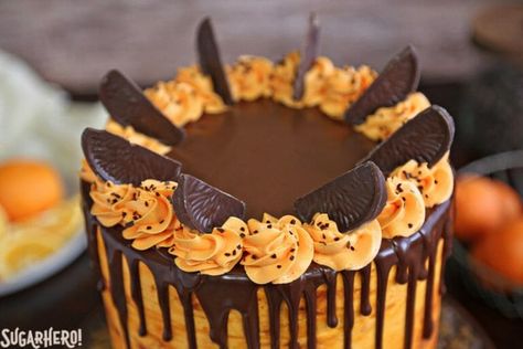 Chocolate-Orange Cake - If you love chocolate-orange flavors, this cake is for you! It's a delicious chocolate cake filled with tangy orange buttercream and topped with chocolate oranges. | From SugarHero.com Terrys Chocolate Orange Cake, Orange Cake Decoration, Orange Layer Cake, Chocolate Raspberry Mousse Cake, Halloween Cake Recipes, Chocolate Orange Cake, Orange Buttercream, Terry's Chocolate Orange, Orange Chocolate Cake