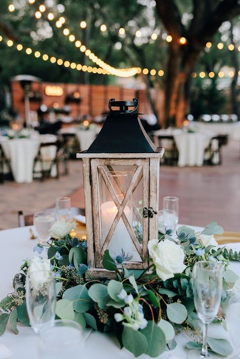 Lantern And Eucalyptus Centerpiece, Wedding Table Centerpieces Sage Green, Eucalyptus Wedding Circle Table, Round Table Centerpieces Wedding With Lantern, Greenery Centerpiece Wedding Round Table, Wood And Eucalyptus Wedding, Lantern Centre Pieces, Lantern With Greenery Centerpiece, Eucalyptus Table Decor Wedding