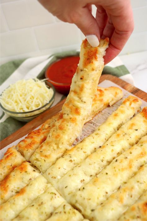 Homemade Cheesy Breadsticks - Delicious garlic pizza crust breadsticks brushed in buttery garlic and layered with cheese. Melty, bubbly, cheesy perfection! Garlic Bread With Pizza Crust, Marcos Pizza Cheesy Bread, Cheesy Garlic Bread Sticks Recipe, Garlic Bread Pizza Crust, How To Make Cheese Bread Sticks, Pizza With Cheese Crust, Copycat Pizza Hut Cheese Sticks, Garlic Bread Sticks Pizza Dough, Cheesy Bread Sticks Recipe