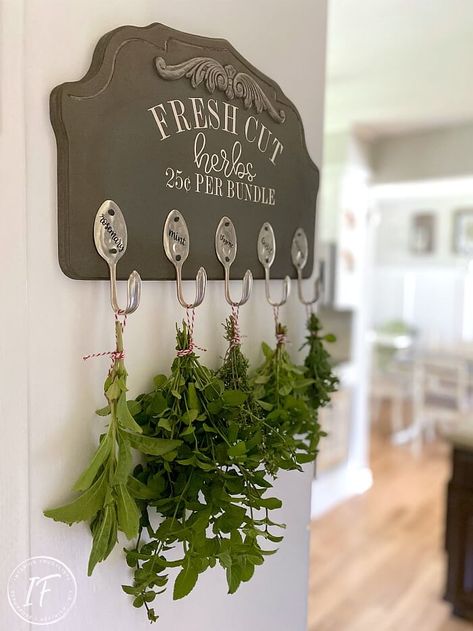 How to make a Kitchen Herb Drying Rack with a repurposed wooden house plaque and recycled silverware spoons for hanging fresh herbs. Its farmhouse style makes it charming kitchen decor on a budget too by Interior Frugalista Kitchen Decor On A Budget, Kitchen Wall Rack, Herb Drying Rack, Herb Rack, Herb Drying, Recycled Silverware, Witchy Kitchen, Herb Wall, Hanging Herbs