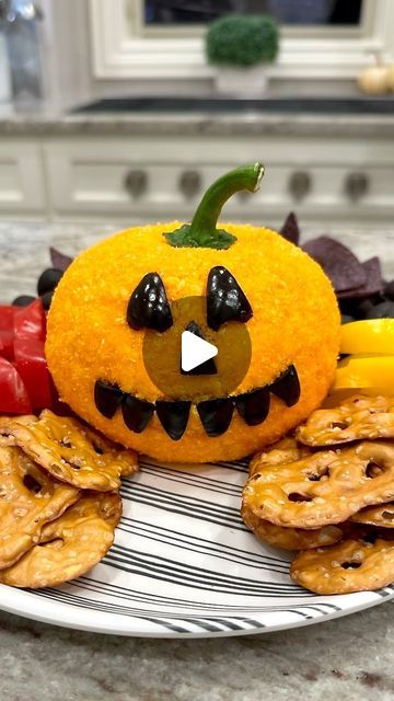 Maegan Brown ~ The BakerMama on Instagram: "Carve some YUM! into your Halloween fun with this festive Jack-O’-Lantern Cheese Ball! 🎃 a bright mixture of shredded cheddar and cream cheese rolled in a crushed Cheetos coating and decorated with olives, it makes a festive, fun and yummy appetizer for your Halloween get-togethers! RECIPE BELOW ⬇️ and at the link in my profile! Follow @thebakermama for more fun and yummy recipes! 🧡 #TheBakerMama JACK-O’-LANTERN CHEESE BALL Ingredients: 🎃 16 ounces cream cheese, softened 🎃 2 cups shredded orange cheddar cheese 🎃 2 cups crushed Cheetos, divided (about an 8.5 ounce bag) 🎃 1/2 teaspoon kosher salt 🎃 5 extra large black olives, for decorating 🎃 1 red bell pepper stem Instructions: 1. Crush Cheetos into tiny pieces, almost like Cheeto dust. Se Cheetos Recipe, Cream Cheese Rolls, Jack O Lantern Faces, Halloween Appetizers, Cheese Rolling, Black Olives, Cheese Ball, Appetizer Dips, Red Bell Pepper