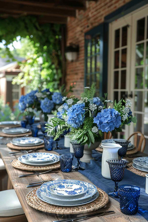 40 Elegant Outdoor Table Decor Ideas for a Classy Affair End Of Summer Tablescapes, White Blue Table Setting, Garden Dining Table Decor, Summer Plates Table Settings, Beach Table Setting Ideas, Patio Dining Table Decor Ideas, Square Plate Table Setting Ideas, Blue Hydrangea Tablescape, Summer Outdoor Entertaining