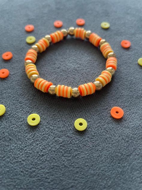 aesthetic orange and yellow bracelet! Sunset Bracelet, Aesthetic Bracelets, Aesthetic Orange, Orange Bracelet, Yellow Bracelet, Clay Bracelet, May 2023, Bracelet Ideas, Orange And Yellow