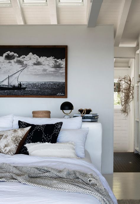 White linen bedroom with black cushions in coastal home with white floors and walls inspired by Italy. #coastal #coastalstyle #coastalbedroom #monochromebedroom #homebeautiful White Beach Bedroom, Black And White Coastal Decor, White Coastal Bedroom, Florida Home Decorating, Old Beach House, Coastal Cottage Bedroom, White Floorboards, Modern Beach Decor, Monochrome Bedroom