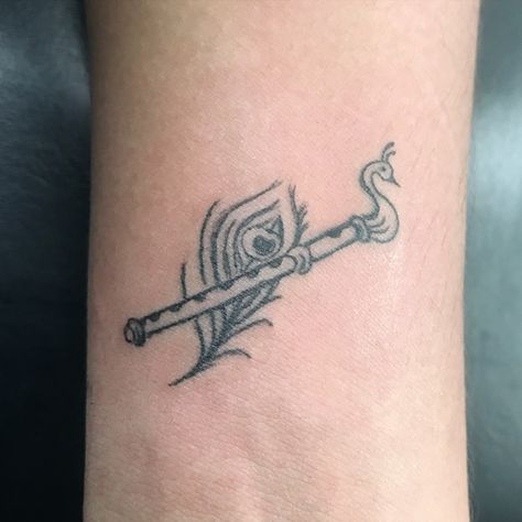 ♥️Flute with peacock feather #tattoo #flutetattoo #flutewithpeacockfeathertattoo #smalltattoo #wristtattoo #krishna #radhakrishna #love #bond Flute With Peacock Feather, Radhakrishna Love, Flute Tattoo, Peacock Feather Tattoo, Feather Tattoo, Peacock Feather, Wrist Tattoos, Small Tattoos, Krishna