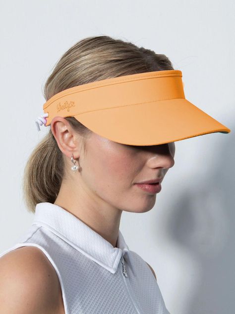 Model: Marina Visor Style: DS1000075.154, DS001-600, 343-600 Available Colors: White-100, Black-999, Navy-590, Birch-115, Dahlia-894, Pacific-566, Rose-800, Sandy-306 The Marina Visor functions as both a sun shade and an accessory to keep your hair out of your eyes. The shaded visor has an anti-glare green underside and a soft, sweat-wicking terry cloth interior. Adjust the size using the elasticated band at the back. Marina Visor is a golf visor with anti-glare green underside to counteract sun Golf Visor, Navy Accessories, Visor Hats, Cute Hats, Sun Shade, Terry Cloth, Elastic Band, Your Eyes, Violet