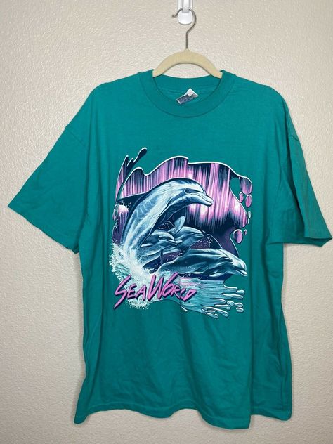 VINTAGE SEA WORLD XL TShirt Green Dolphin Graphic Tee Single Stitch Unisex Beefy Photos are of actual item you will receive. Shirt is in excellent pre-owned condition with minimal signs of wear. There is a small stain above the graphic. See photos. length: 28" pit to pit: 22.5" sleeve: 8" Aztec Clothing, Dolphin Graphic, Green Dolphin, Vintage Sea, Vintage Nature, Sea World, Dolphins, Graphic Tee, Design Ideas