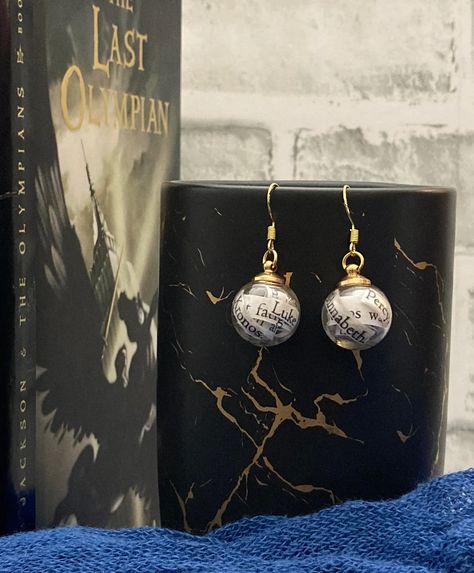 Step into the epic finale with our Percy Jackson Book Earrings, carefully crafted from the pages of The Last Olympian. These earrings showcase iconic characters like Percy, Annabeth, and more, capturing the essence of demigod heroism and the ultimate battle against Kronos. Whether you're a fan of prophecy or simply displaying your love for the series, these earrings are a captivating addition to your style. ⚔📖⚡ #PercyJacksonJewelry #BookishEarrings #DemigodFashion Percy Jackson Jewelry, Percy Annabeth, Harry Potter Earrings, The Last Olympian, Book Earrings, Percy Jackson Books, Book Jewelry, Gifts For Bookworms, Greek Myths