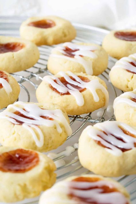 These melt-in-your-mouth thumbprint cookies are sweet and buttery, with that wonderful soft jammy center we all love. And especially good for the holidays. They brought raves from my office colleagues. The glaze adds an extra layer of yumminess. Easy Bake Sale Recipes, Easy Bake Sale Treats, Strawberry Jam Cookies, Office Colleagues, Bake Sale Treats, Jam Thumbprint Cookies, Kitchen Notes, Baking School, Bake Sale Recipes