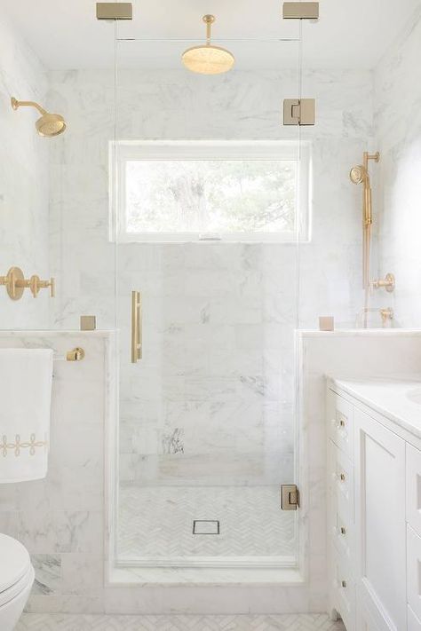 A brass and lucite towel holder lines a glass and marble shower enclosure filled with white marble tiles lined with a brushed brass shower kit alongside a white marble herringbone tile shower floor. Bathroom Measurements, Bathroom Plan, Bathroom Plans, Bilik Air, Marble Showers, Bad Inspiration, Bath Ideas, Bathroom Reno, Cool Ideas