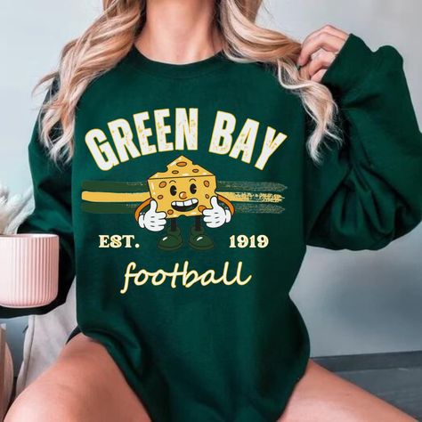 Womens Green Bay Football Sweatshirt, Green Bay Football Fan Shirt, Green Bay Game Day Shirt,Green Bay Fan Gift, Greenbay Crewneck SHIPS IN 1-2 BUSINESS DAYS.. PLEASE IGNORE ETSY'S SHIPPING TIMES, IT IS NOT ACCURATE    .: Made with a medium-heavy fabric blend of 50% cotton and 50% polyester (8.0 oz/yd² (271.25 g/m this sweatshirt feels cozy and is the perfect choice for those colder months. .: The classic fit along with the crew neckline deliver a comfy wearing experience with a clean-cut style. Meanwhile, the double-needle stitching at the shoulder, armhole, neck, waistband, and cuff seams add top-tier durability.  .: Say goodbye to itchiness thanks to the gray, pearlized tear-away label.  .: Made using 100% ethically grown US cotton. Gildan is also a proud member of the US Cotton Trust P Green Bay Packers Clothing, Green Bay Packers Sweatshirt, Football Fan Shirts, Green Bay Packers Shirts, Cute Shirt Designs, Football Sweatshirt, Game Day Shirts, Fan Shirts, Clean Cut