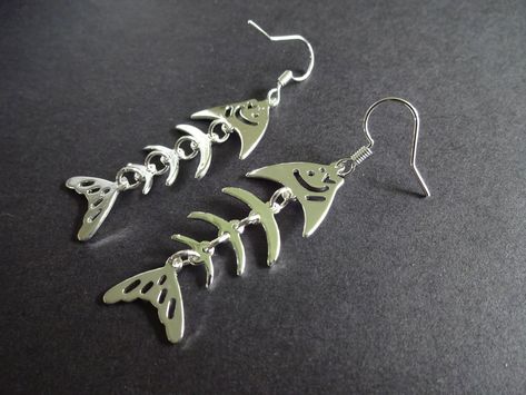 This listing is for a Brass metal pair of fishbone dangle earrings. Each dangle earring is made of a whimsical fishbone skeleton pattern.  Each earring is about 59mm long and 17mm wide. The earrings feature a fish hook style for pierced ears.  Jewelry Type- Earrings Jewelry Sub-Type- Metal Earrings, Dangle Earrings Style- Classic, Fun, Modern   Size/Length- about 59mm long, 17mm wide Pendant Type - Brass Pendant Color- Silver   Hook Type- Fish Hook   Hook Color- Silver  Metal Type- Brass  Why sh Ears Jewelry, Skeleton Pattern, Fish Bones, Skeleton Design, Funky Earrings, Earrings Metal, Clothes Shopping, Fish Bone, Special Jewelry