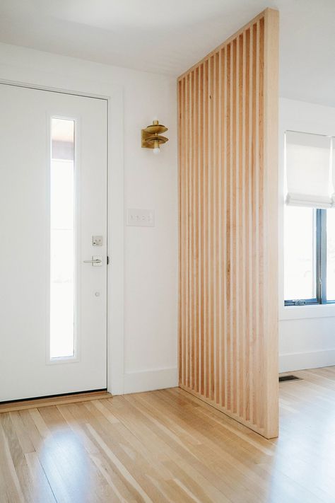 Slat Wall Separation, Wall Divider Entryway, Slat Wall Divider Entry, Light Wood Mid Century Modern, Wood Slat Divider Wall Entryway, Wood Dividing Wall, Slat Wall Front Entrance, Entry Room Divider Ideas, Vertical Slat Room Divider