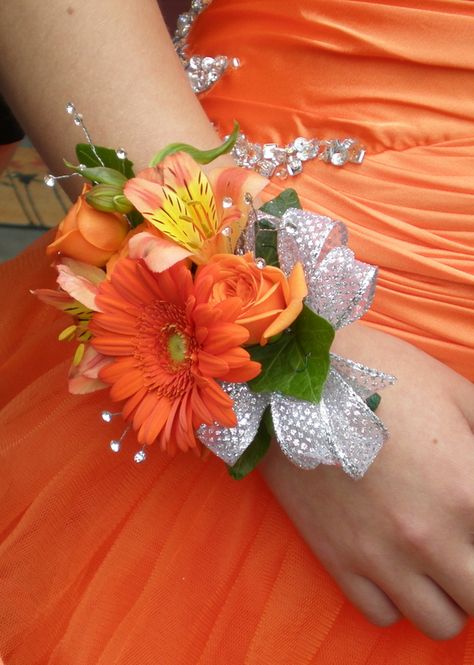 Wrist corsage with orange alstromeria and gerbera daisy with silver Flower Prom Nails, Daisy Bridal Bouquet, Prom Flowers Corsage, Bracelet Corsage, Homecoming Flowers, Prom Corsages, Prom Corsage And Boutonniere, Wrist Corsage Prom, Homecoming Corsage