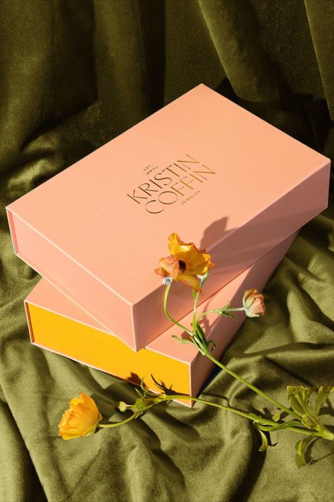 Nice People has artfully designed the packaging for Kristin Coffin Jewelry, employing a sumptuous color palette of luxuriously creamy pastels. These elegant hues are complemented by a refined typography system and exquisite gold foil details, striking a harmonious balance that melds timeless and modern elements. Kristin Coffin Jewelry, Coffin Jewelry, Packaging Design Ideas, Boxes Packaging, Beer Packaging, Graphic Design Packaging, Peach Fuzz, Beverage Packaging, Branding Packaging