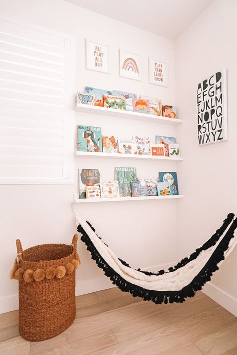 One of the kid's favorite spots in the house is this reading corner in their playroom! I made this book wall to display all their favorite books and added a cute kid hammock! It is a functional yet pretty spot to store all their favorite books! #sponsored #buybuybaby #babyhood #bookwall #readingcorner #playroomideas #playroomdecor Toy Room Reading Corner, Reading Corner Mural, Playroom Reading Corner Cozy, Playroom Hammock, Hammock In Bedroom Kids, Kids Hammock Bedroom, Reading Corner Girls Bedroom, Boys Reading Corner, Reading Corner Playroom