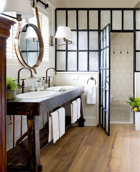 So many beautiful things about this bathroom; the barrel-hoop mirror, the factory window room divider, dark brass hardware, and that SINK stand!! Amazing. Farmhouse Bathroom Decor Ideas, Farmhouse Bathroom Vanity, Bad Inspiration, Modern Farmhouse Bathroom, Subway Tiles, Farmhouse Bathroom Decor, Bathroom Renos, Rustic Industrial, Farmhouse Bathroom