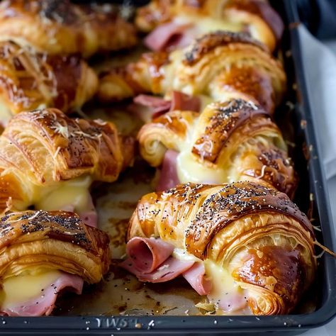 These ham and cheese croissants are quick and easy to make with just a few ingredients. The combination of flaky, buttery croissants with savory ham, gooey cheese, and the honey mustard glaze is delicious! Han And Cheese Croissant, Toasted Ham And Cheese Croissant, Breakfast Croissant Bake, Croissant Ham And Cheese, Ham And Cheese Croissant Recipe, Honey Croissants, Mini Crossaints Sandwiches, Ham And Cheese Croissants, Baked Ham And Cheese Croissants