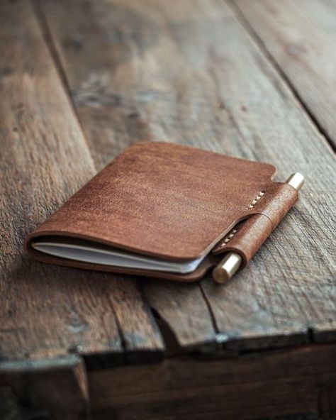 "Handmade leather journal with a place for pen. Write something down, sketch an idea or just keep a diary. This refillable notebook cover is made with 2mm (5oz) full grain leather so it will shield your important content. It's very minimal and convenient as the pen slot keeps the cover closed. In this leather notebook cover there's room for two interchangeable notebooks (9cm x 14cm / 3.5\" x 5.5\") that are the standard sized Moleskine, Field Notes and Word notebooks. The default package contains the brass pen and one blank Luava notebook (48 pages). You can add a 3-pack to the order if you want.  The package comes with a brass ballpoint pen that has interchangeable ink cartridge (pilot g2 refill) and that is very unique in its minimalistic form. It comes with one cartridge filled with bla Check Book Covers, Leather Sketchbook Cover, Leather Moleskine Cover, Handmade Leather Notebook, Brown Leather Journal, Refillable Notebook, Diy En Cuir, Leather Sketchbook, Leather Book Covers