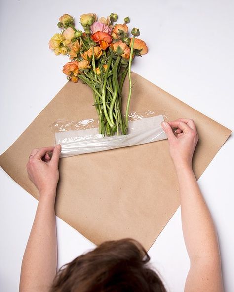 Here, a damp paper towel wrapped in plastic wrap and tucked inside brown paper wrapping will keep 'em looking healthy. Wrap A Bouquet, Wrap Flowers, Brown Paper Wrapping, Arranging Flowers, Diy Flores, Flower Truck, How To Wrap, Bouquet Preservation, Cut Flower Garden