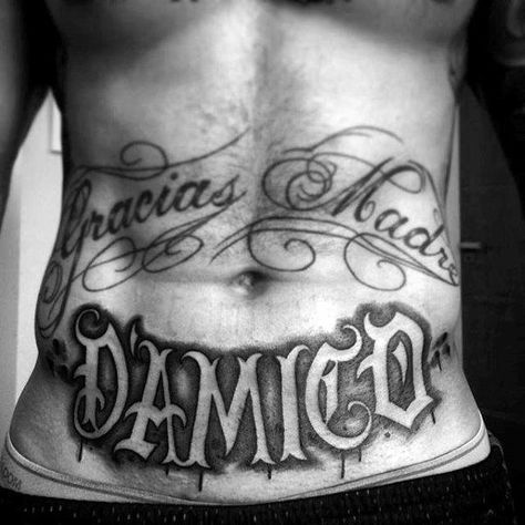 Lower Stomach Old English Male Name Tattoo Lower Abdomen Tattoo Men Ideas, Under Belly Tattoo Men, Stomach Script Tattoos Men, Last Name Stomach Tattoos, Stomach Writing Tattoo, Stomach Tattoos Lettering, Stomach Tattoos For Guys Words, Men’s Stomach Tattoo Designs, Lower Abs Tattoo Men