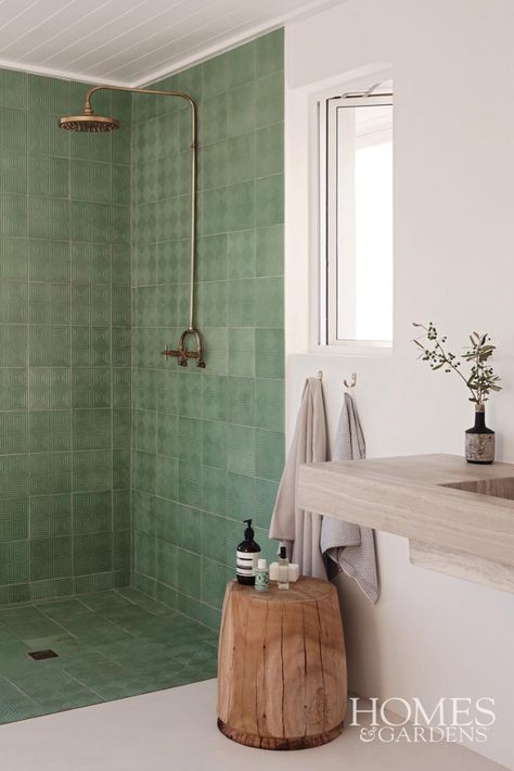 This modern wet room has used green patterned tiles to create the frame of the shower meaning that there is no glass needed in this wet room bathroom. Natural textures, materials and colours have been incorporated into this bathroom to complement the properties surrounding landscape. Wooden furniture brings a sense of character into the bathroom with various wood colourings and the brass furnishings bring a touch of glamour Modern Wet Room, Bathroom Natural, Wet Room Bathroom, Patterned Tiles, Wet Room, Bathroom Furnishings, Beach City, Brass Bathroom, Green Tile