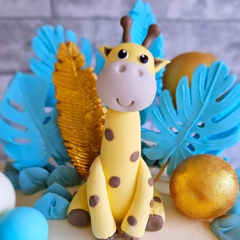 The sweetest cake with the cutest handmade animals! Blue, beige, and gold themed cake for a 1st birthday celebration today! Vanilla cake filled with nutella buttercream and hazelnut buttercream to decorate. Gold Themed Cake, Hazelnut Buttercream, 1st Birthday Celebration, Nutella Buttercream, Handmade Animals, Fondant Cake Topper, Fondant Cake Toppers, Fondant Toppers, Cute Giraffe