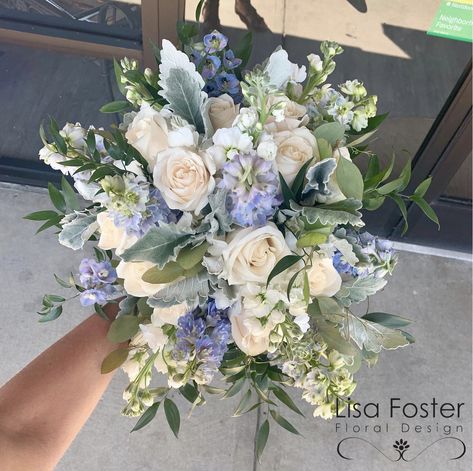 This is a gorgeous blue and white bouquet for all your wedding dreams to come true.  It is filled with blue delphinium; white roses; dusty miller; white stock.   It is beautiful and simple, yet brings everything together.   Lisa Foster Floral Design   www.lisafosterdesign.com Lavender Blue And White Bouquet, Blue Hydrangea White Lily Bouquet, Bridal Bouquet Delphinium, Delphinium Wedding Bouquet, Blue Delphinium Wedding, Blue Delphinium Bouquet, Light Blue Bouquet, Magnolia Wedding Flowers, Blue And White Bouquet