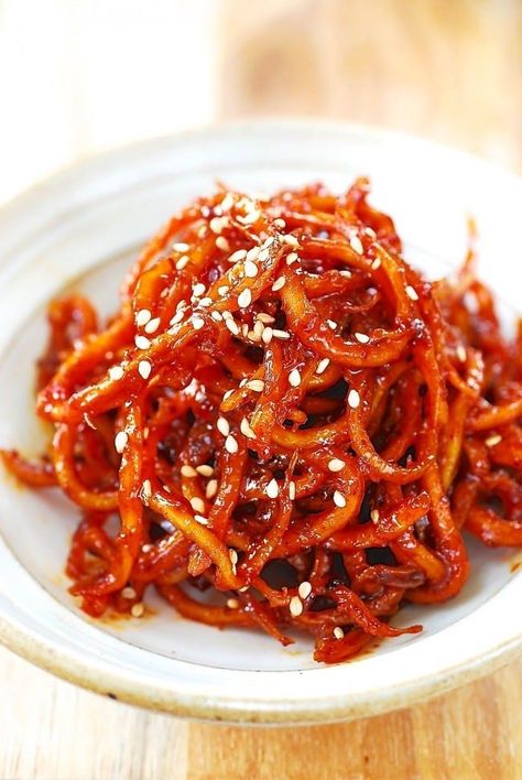 Ojingeochae (o-jing-eo-chae, 오징어채) is dried squid that’s shredded and processed with seasoning such as sugar and salt. It’s slightly sweet with a hint of saltiness. Ojingeo is squid, and chae means shredded or julienned. It’s also called jinmichae (진미채). Jinmi means tasty. It’s commonly enjoyed as a snack on its own, especially when drinking alcohol, … Korean Squid Recipe, Authentic Korean Food, Dried Squid, Squid Recipes, Korean Side Dishes, Korean Cooking, Spicy Korean, Korean Dishes, Pacific Islands