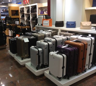 How To Choose Luggage For Business Travel - Forbes Bag Store Display, Bag House, Coffee Shop Logo Design, Retail Store Interior Design, Store Design Boutique, Coffee Shop Logo, Retail Store Interior, Luggage Shop, Utility Storage