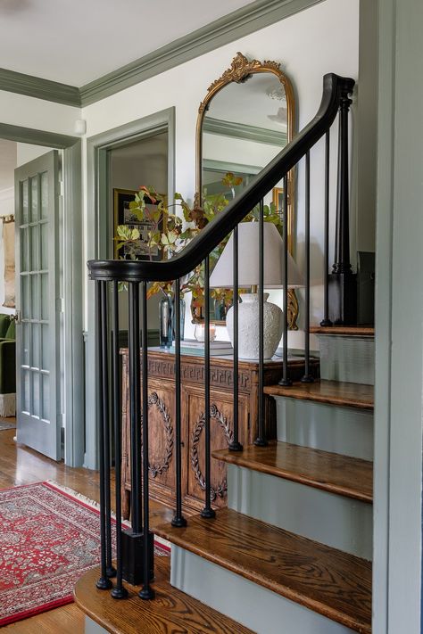 7 ways to update your foyer using paint, stain, lighting, and decor to create an upscale modern traditional look for less. Hallway Bannister Ideas, Natural Wood Stair Railing, Colonial Staircase Entryway, Wooden Bannister Ideas, Old Staircase Makeover, Painting Stair Railings, Front Entryway Ideas With Stairs, Updating Staircase, Paint Stair Railing