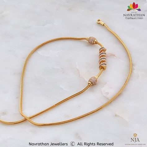 Fancy Mope Chain/ Mangalya Chain: This Mangalya Chain harmonises culture with present day fashion and displays your bond in exuberant gold. Walk into our stores and get your hands on it or visit us at www.navrathan.com and get your hands on it faster.  #Jewellery #Navrathan #Jewellers #Gold #Silver #Diamond #GoldNecklaceDesign #SilverArticles #PlatinumJewellery #TempleJewellery #BridalCollection #BridesOfIndia #AntiqueJewellery #Ring #Earring #Necklace #GiftCollection #DiamondFingerRing Mangalya Chain With Mop, Thali Kodi, Navrathan Jewellers, Mugappu Chain, Thali Chain, Gold Necklace Design, Antique Necklace Gold, Gold Bridal Necklace, Gold Jewels Design